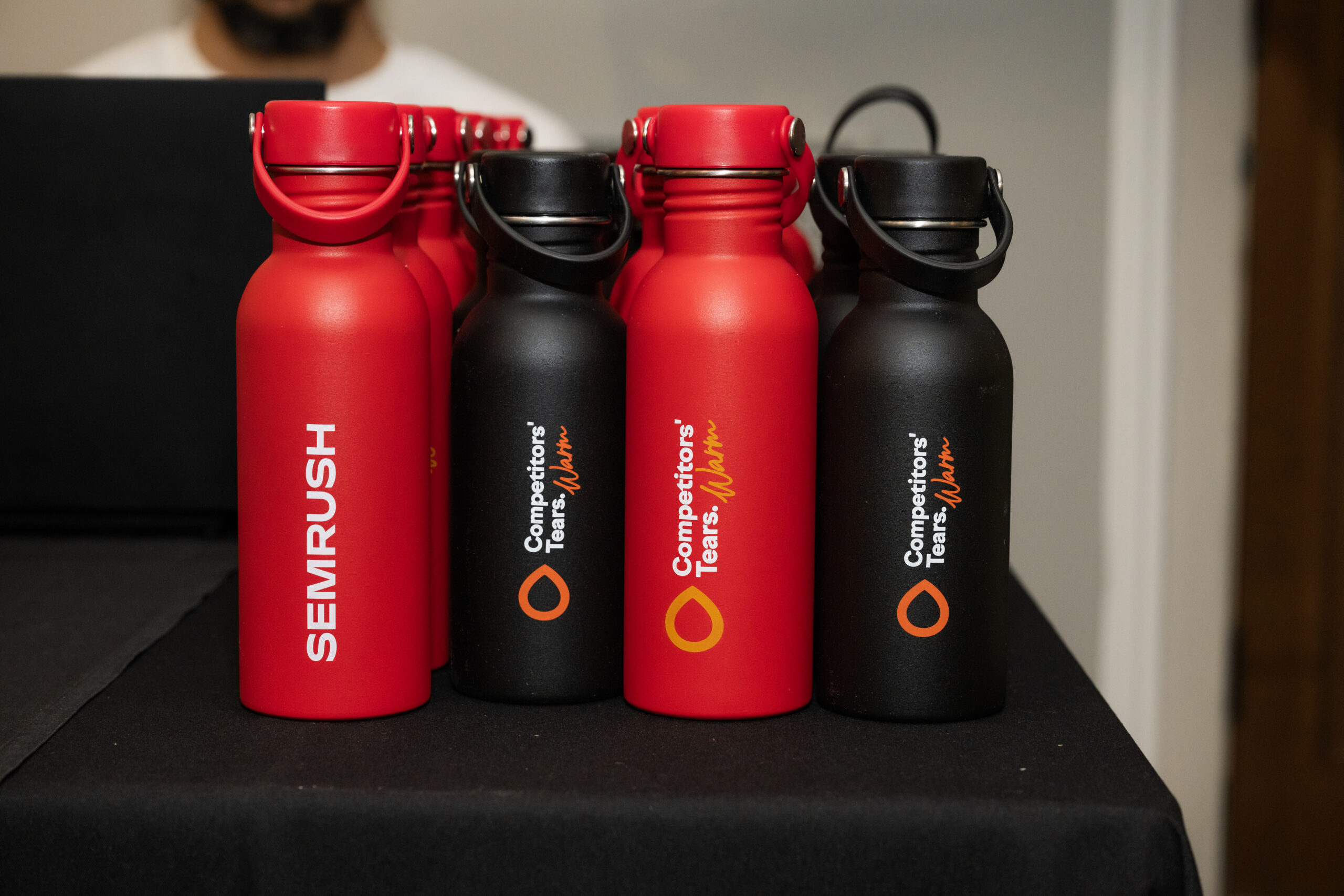 Semrush red and black water bottles sitting on a table
