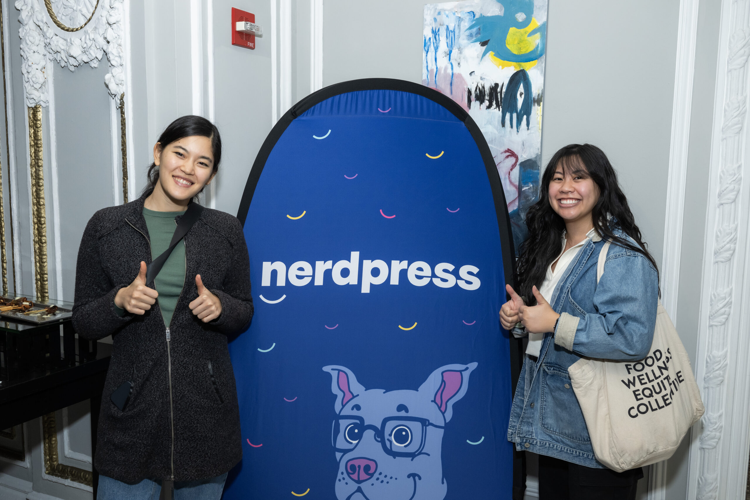 two women posing with NerdPress banner